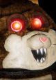 Mama from Tattletail with glowing red eyes and a menacing grin, showcasing her distinctive furry texture and heart marking.