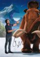 Ray Romano poses with Manfred from Ice Age, showcasing the beloved mammoth in a vibrant snowy landscape.