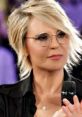 Maria De Filippi, renowned Italian television presenter, showcases her signature style with glasses and a confident expression.