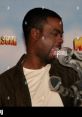 Chris Rock interacts playfully with a Marty the Zebra puppet, showcasing a fun moment from Madagascar promotion.