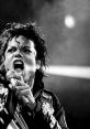 Michael Jackson passionately singing on stage, showcasing his iconic style and powerful stage presence.