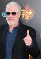 Ron Perlman, the narrator of "The Book of Life," gives a thumbs up at the film's premiere, exuding charm and confidence.