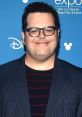 Josh Gad smiles at a Disney event, representing Olaf from Frozen. Celebrating the beloved snowman character's legacy.