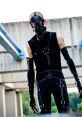 Psycho Mantis cosplay featuring a character in a gas mask and dark outfit, embodying stealth and mystery in a urban setting.