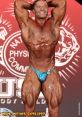 Renato Cariani 3.0 showcasing impressive muscles at a bodybuilding competition with a confident smile and striking pose.