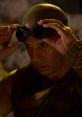 Richard B. Riddick adjusts his goggles, preparing for action in The Chronicles of Riddick, showcasing a fierce determination.