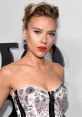 Scarlett Johansson exudes elegance in a sparkling strapless gown, showcasing bold red lips and statement earrings.