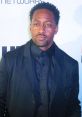 Jaleel White attending an event, showcasing his iconic role as Sonic the Hedgehog, dressed in a sleek black attire.