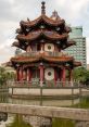 Traditional pavilion at 2 28 Peace Park, surrounded by water and modern cityscape, showcasing unique architecture and tranquility.