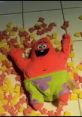 Cheerful Patrick Star plush toy lying on the floor surrounded by colorful foam blocks, capturing a playful moment.