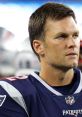 Tom Brady focuses intently during a Patriots game, showcasing determination and leadership on the field.