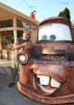 Larry the Cable Guy poses beside Tow Mater from Cars, showcasing the beloved character’s iconic smile and rustic charm.