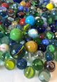 Marbles The of marbles being spilled from a bag onto a table is a delightful cacophony of tinkling glass. As each marble