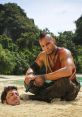 Vaas Montenegro, voiced by Michael Mando, menacingly confronts his victim on a tropical beach in Far Cry 3.