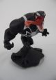 Venom figure from Disney Infinity-Marvel poses aggressively on a rocky base, showcasing detailed black and white design.