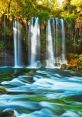 Waterfall The of a waterfall cascading down into a river is a symphony of nature's . The rushing water tumbles over rocks