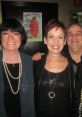 Wanda (Susanne Blakeslee) smiles with friends, showcasing her vibrant personality at a lively event, dressed stylishly.