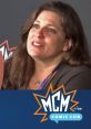 April Stewart, voice of Wendy Testaburger, shares insights at MCM Comic Con, engaging with fans in a vibrant atmosphere.