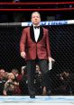 Bruce Buffer announcing at a UFC event, dressed in a stylish tuxedo, engaging the crowd with excitement.