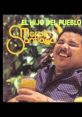 Marvin Santiago enjoying a drink, smiling among lush greenery, featured in "El Hijo del Pueblo." Classic Latin music vibe.