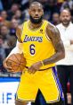 LeBron James in Lakers uniform, poised with a basketball, showcasing his skills on the court during an NBA game.