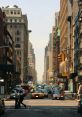 Busy urban street scene with cars, pedestrians, and tall buildings under a bright sky in a metropolitan area.