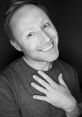 Smiling portrait of Limmy (Brian Limond) expressing joy, showcasing his charismatic personality and engaging demeanor.