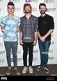 AJR pop band members pose for a photoshoot at Q102 Philly, showcasing their unique fashion styles and vibrant personalities.