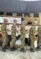 Colombian soldiers participate in community support event, distributing food packages and engaging with local initiatives.