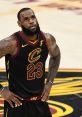 LeBron James in a black Cavaliers jersey, focused and determined during an intense NBA game.