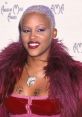 Eve Gemminger at the American Music Awards, showcasing bold fashion and distinctive style with purple highlights and jewelry.