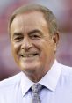 Al Michaels smiling while wearing a light blue shirt and patterned tie, showcasing his charismatic sports commentary style.