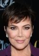 Kris Jenner showcases her signature look with short hair and elegant makeup, exuding confidence at a glamorous event.