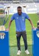 Evan Kindombi Mbemba poses on the field with two prestigious trophies, celebrating his football achievements with Porto.