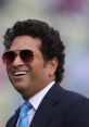 Sachin Tendulkar smiling warmly, wearing sunglasses and a suit, showcasing his iconic personality and charm.