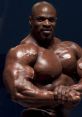 Ronnie Coleman showcasing impressive muscle definition and strength during a bodybuilding competition. Legendary physique.