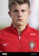 João Costa in a red Portugal training jacket, showcasing athletic demeanor and focus, emblem of national pride.