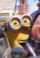 Excited Minion from "Minions: The Rise Of Gru" smiles cheerfully in a bustling urban scene, embodying playful mischief.