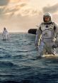 Astronauts exploring a vast ocean, inspired by "Interstellar," against a backdrop of dramatic clouds and light.