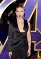 Scarlett Johansson stuns at a Hollywood event in a chic black outfit, showcasing her elegant style and bold makeup.