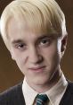 Draco Malfoy with slicked-back platinum blonde hair, wearing a black sweater and a green tie, exuding his trademark arrogance.