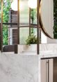 Elegant salon reception area with marble counter, modern lighting, and greenery showcasing Leo Bancroft Salon's stylish design.