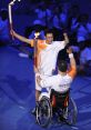 Zhang Hongwei celebrates the Paralympic spirit, passing a torch to a wheelchair athlete at the Beijing 2008 opening ceremony.