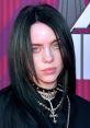 Billie Eilish showcases her iconic style with dark hair and layered necklaces at a red carpet event.