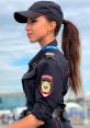 Дарина Юсупова in police uniform, showcasing her role with authority and poise against a sky backdrop.