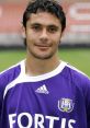 Ahmed Hassan in a purple sports jersey, showcasing his confidence and talent as a professional football player.