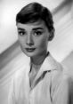 Classic black and white portrait of a young woman with short hair, embodying timeless elegance and grace.