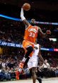 LeBron James performs a powerful dunk in a competitive NBA game, showcasing athleticism and skill on the court.