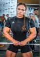 Natalia Klimutko showcasing strength at a weightlifting competition with impressive muscular physique and focused expression.