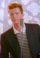 Rick Astley performing "Never Gonna Give You Up," showcasing his iconic hairstyle and vintage microphone on stage.